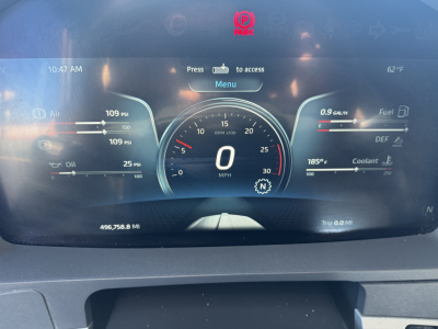 Kenworth T680 gauge cluster display showing speedometer at 0 mph, digital readouts for oil pressure, DEF, coolant, fuel, and trip data. VIN and stock number visible in listing context.