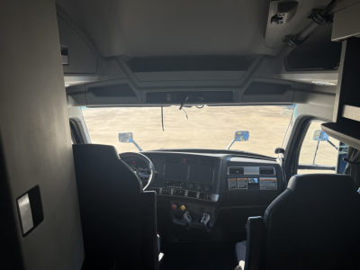 Kenworth T680 truck interior cabin view from driver seat showing dashboard and steering wheel.