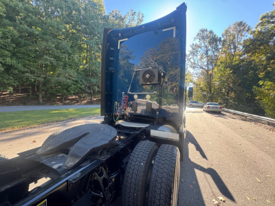 Kenworth T680 sleeper cab rear view showing rear wheels and tractor-trailer hitch area; no visible branding text captured