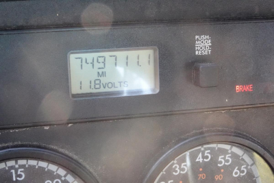 Dashboard gauge cluster with odometer reading 749711.0 miles and 118.0 volts display, brake indicator light, push mode hold reset switch visible.