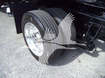 Truck rear dual wheels and suspension components of a 2019 International Durastar 4300 rollback chassis; shows dual rear tires and part of the frame.