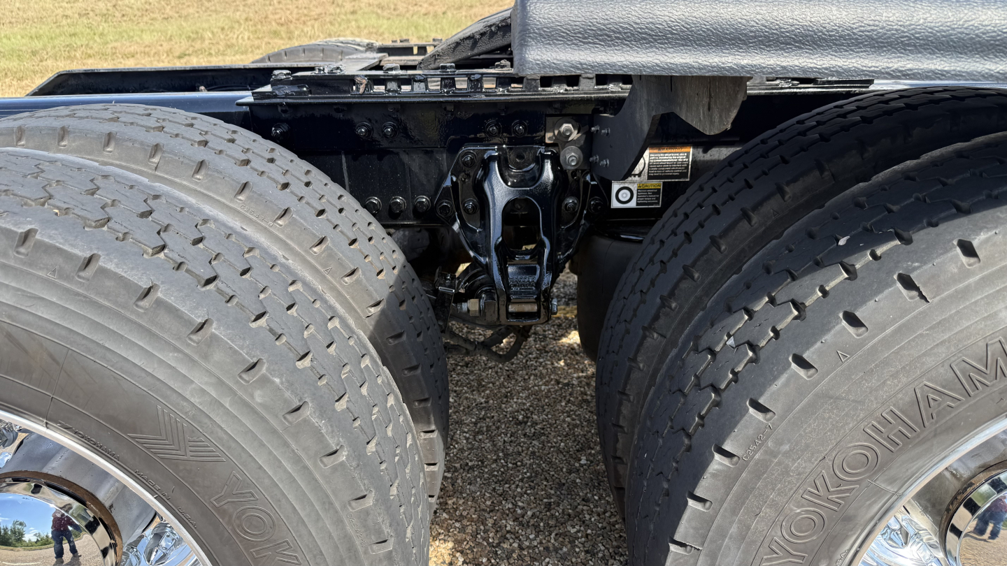 Kenworth W900 chassis view showing rear axle, suspension components, and dual rear tires.