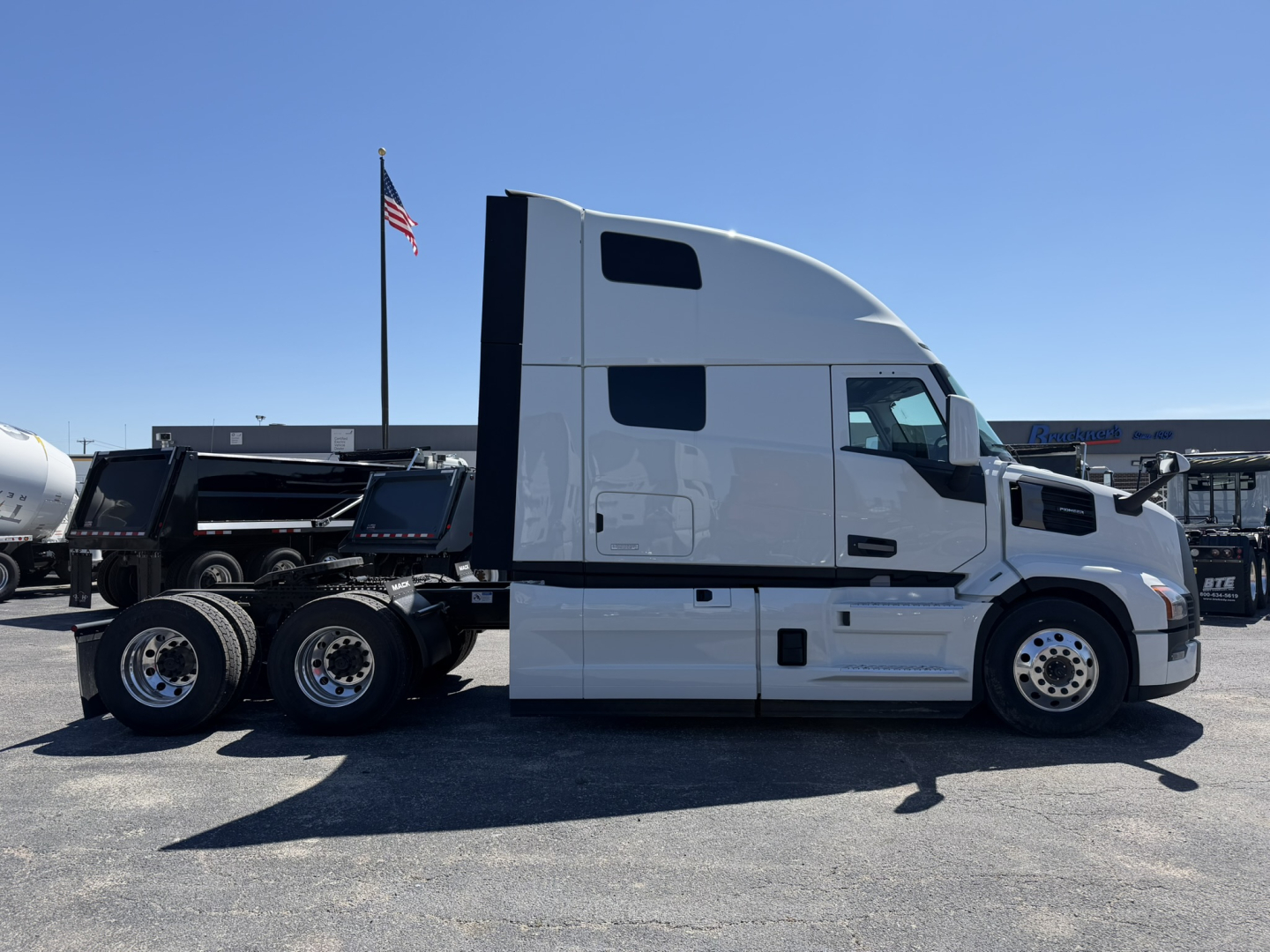 Mack PR64T76H conventional sleeper truck side view showing cab, chassis, tandem rear axles, and fuel tanks.
