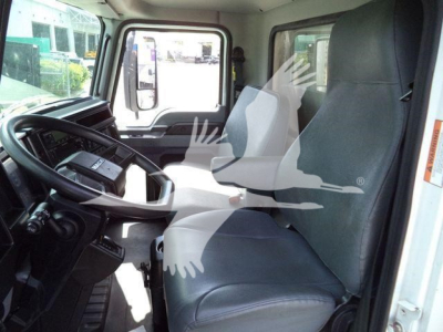 Interior of a 2023 Mack MD6 cab showing driver seat and passenger seat with steering wheel and dashboard.