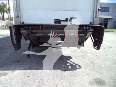 Rear view of a 2023 Mack MD6 refrigerated truck showing undercarriage components and lift mechanisms.