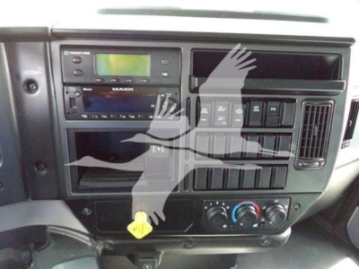 Mack MD6 dashboard area showing radio, climate controls, and multiple switches.