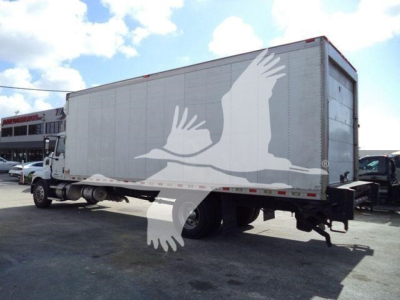 Mack MD6 refrigerated truck on lot showing side and rear, stock number 268303RFM visible in listing.