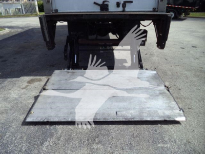 Mack MD6 truck rear with aluminum lift plate/platform for refrigerated body, underside view showing tail area and towing/receiver components.