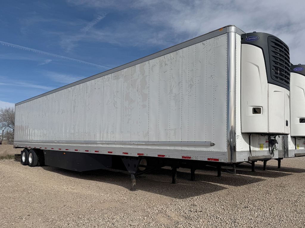 Utility 3000R trailer with reefer unit at the front showing plain silver side panels and a blue sky; side view highlighting the refrigeration unit at the front.