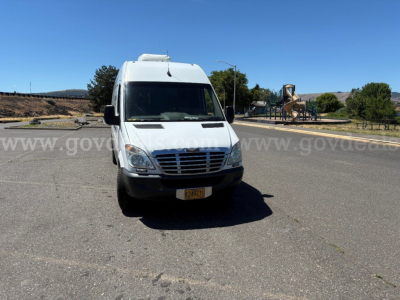 White Freightliner Sprinter van front view with license plate, stock number visible, and watermark across image.