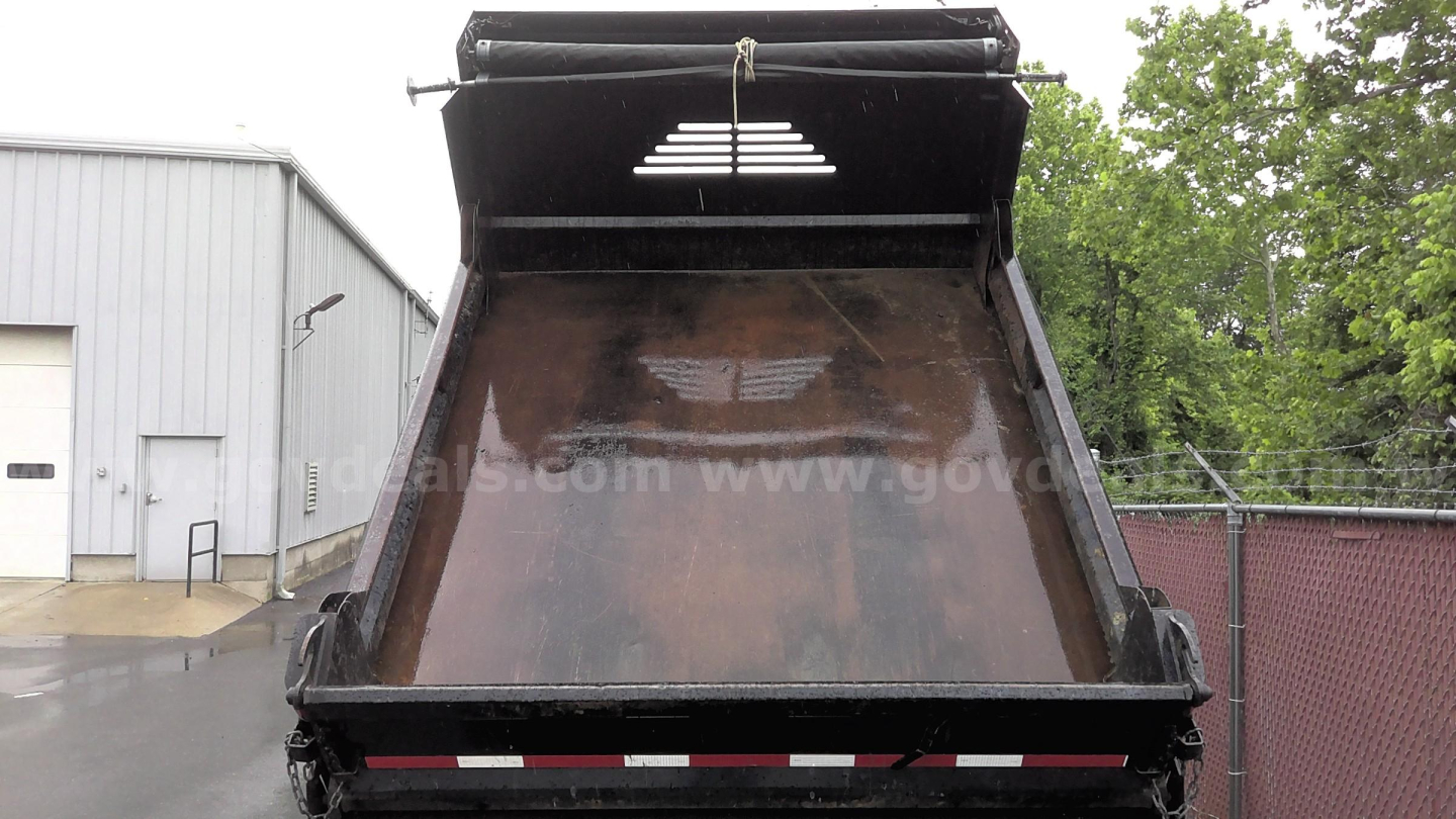 Dump truck bed of a 2013 Ford F-450 showing the cargo bay painted brown with a raised tailgate and black frame.