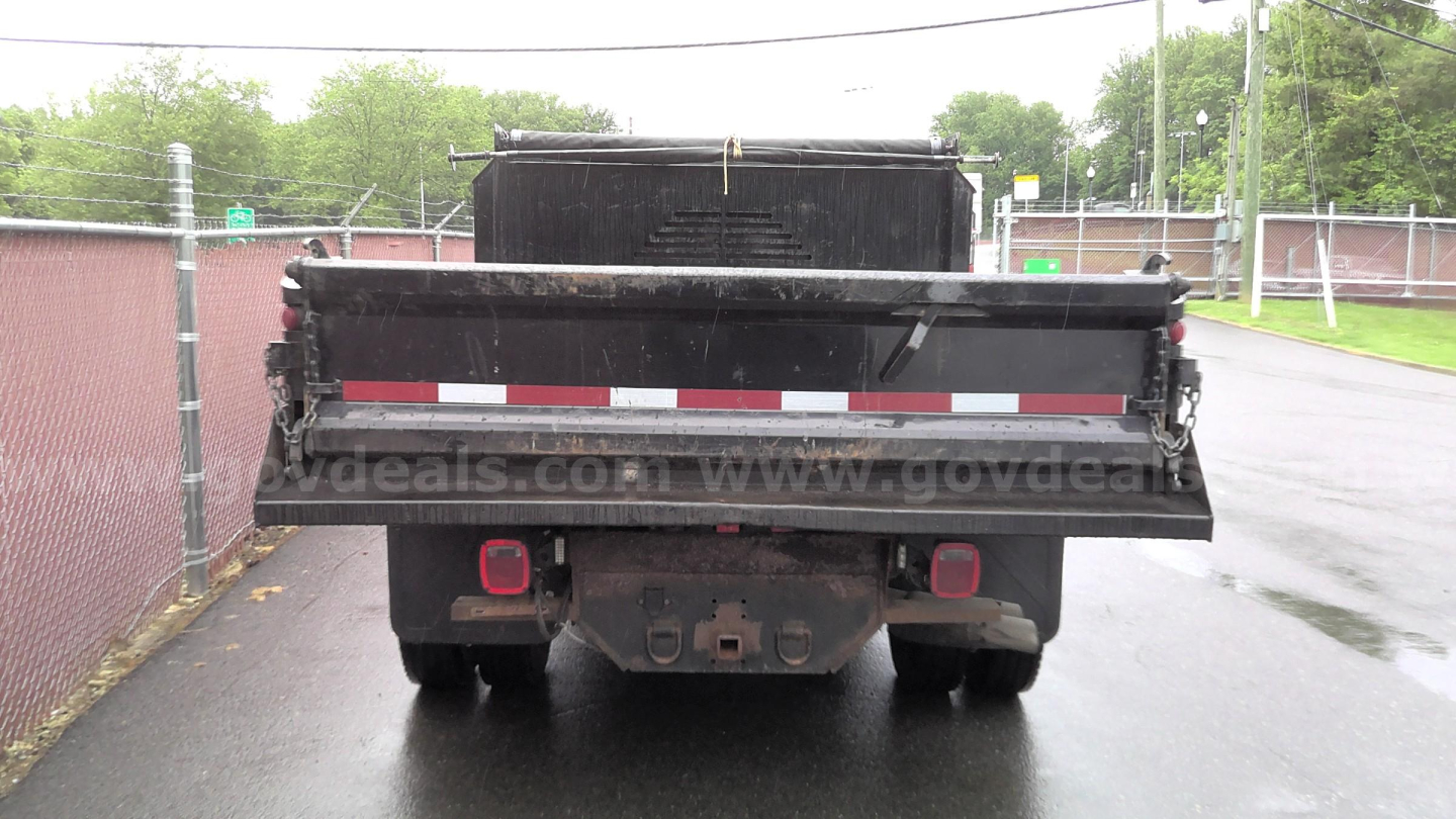 Dump truck bed rear view showing hitch and taillights with reflective stripe