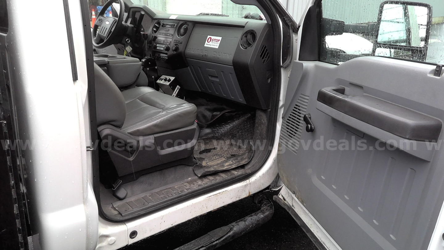Ford F-450 interior showing front driver seat and dashboard with door open; visible truck cabin area