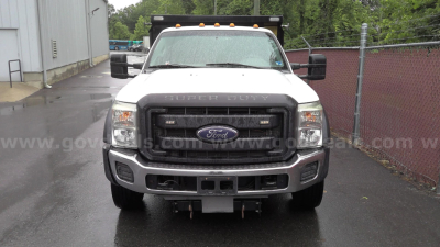 Ford F-450 dump truck front view showing Ford emblem grille and bumper, with yellow clearance lights on cab roof.