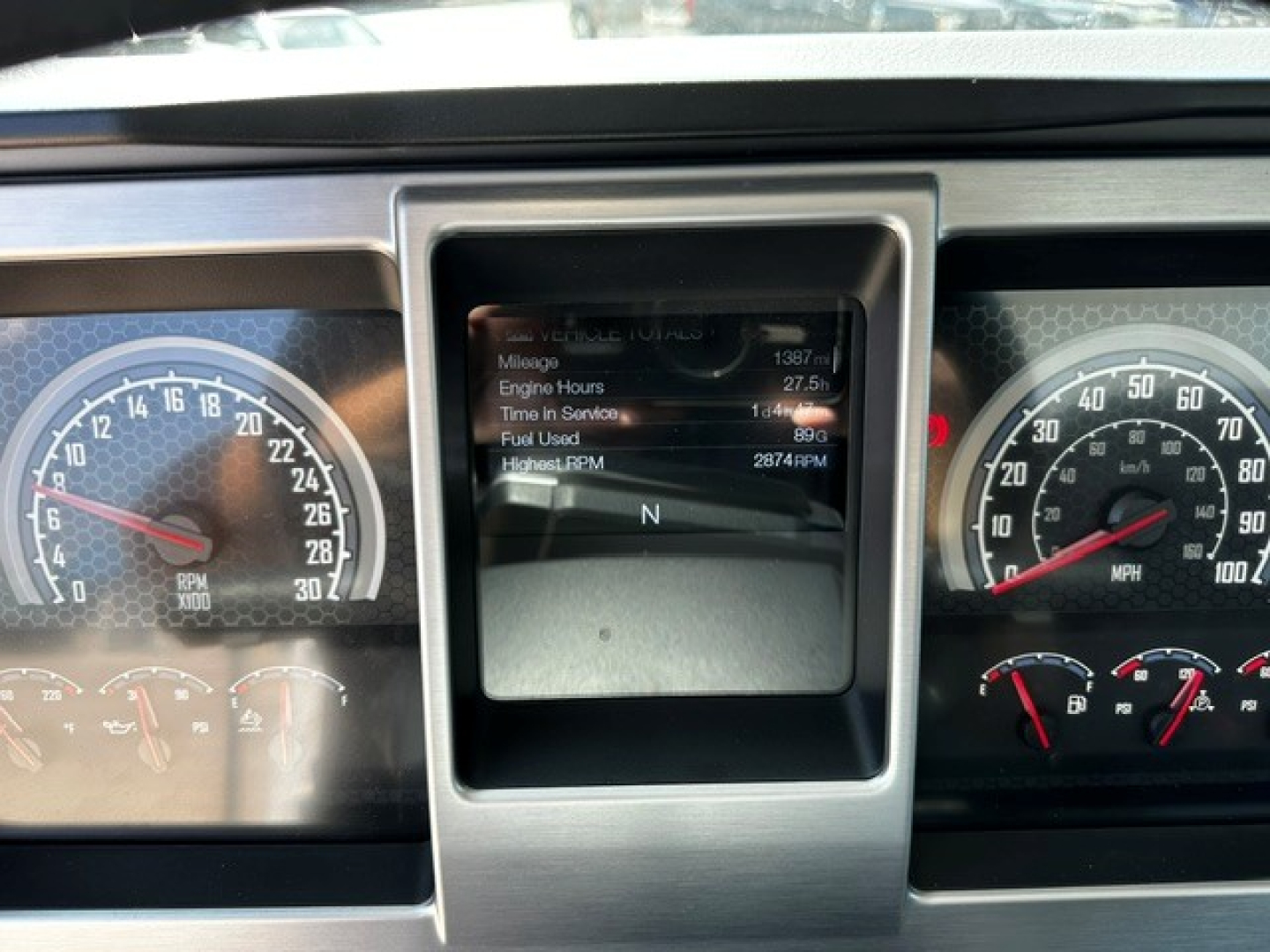 Dashboard of a 2027 Mack MD6 cab showing instrument clusters and a central display with mileage and engine hours readable text.