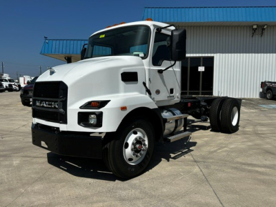Mack MD6 cab and chassis truck showing front grille, headlights, and side view with white cab and dual rear axles.
