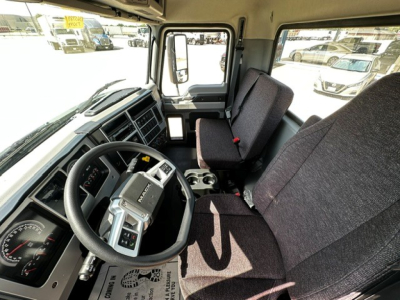 Cab interior of a 2027 Mack MD6 showing steering wheel, driver seat, and dashboard with gauges and controls.
