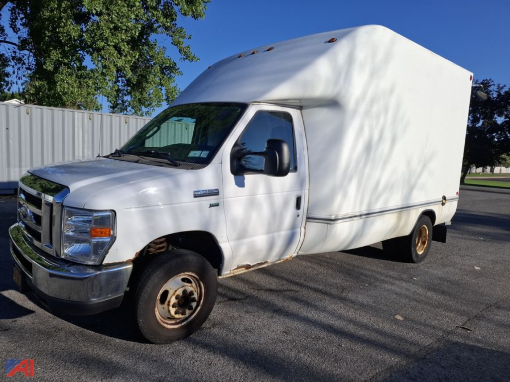 Ford E-350 box truck side view showing cargo box and cab, front grille, headlights, and wheel tires.