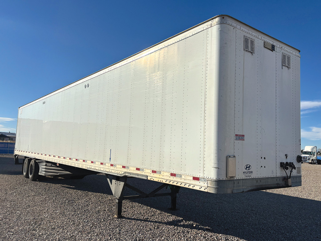 Trailer box showing side and rear views of a white Hyundai aluminum trailer with support legs down.