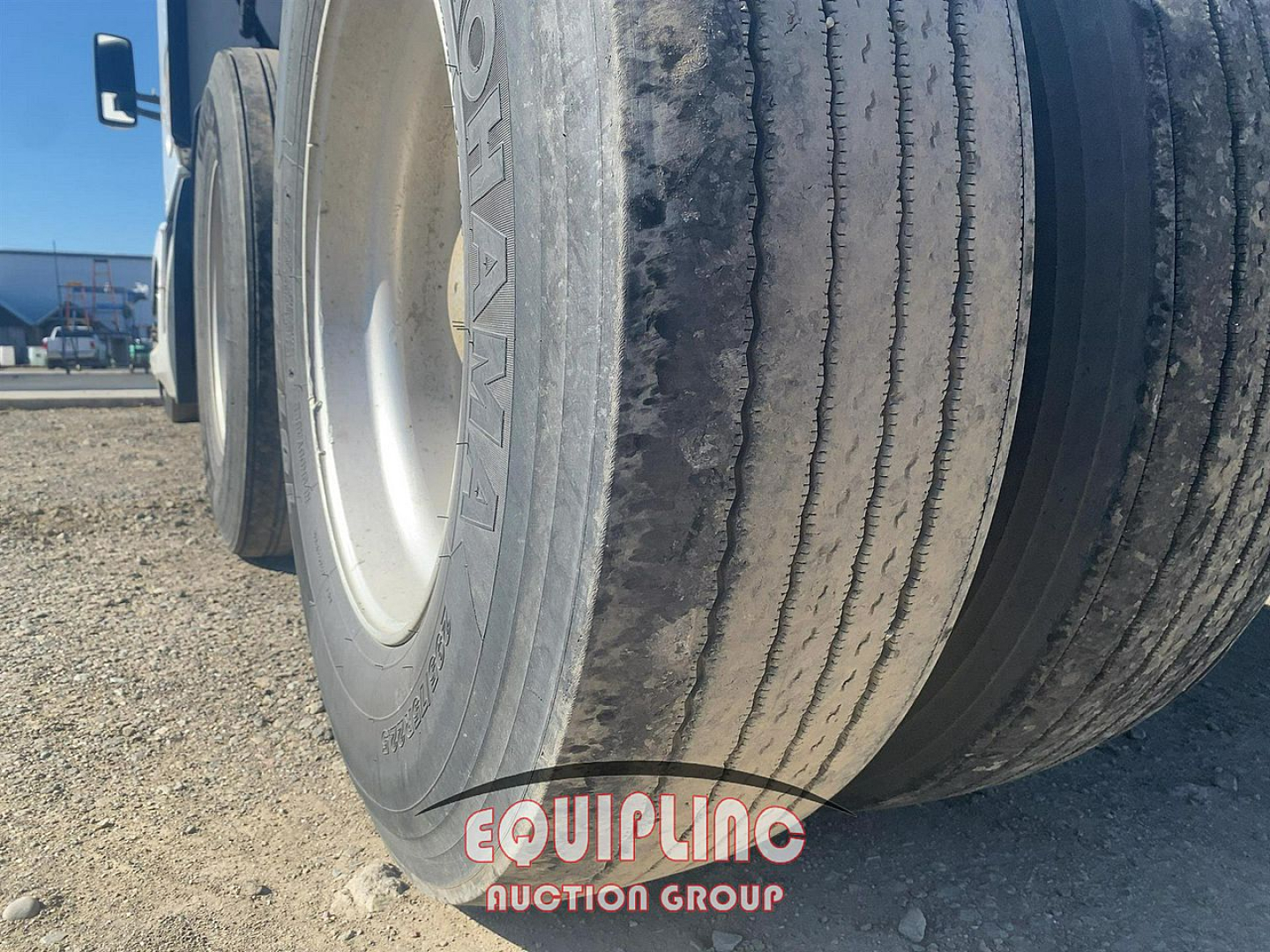 Kenworth T680 front dual tires view showing tire treads and wheel rims, equipment auction watermark present.