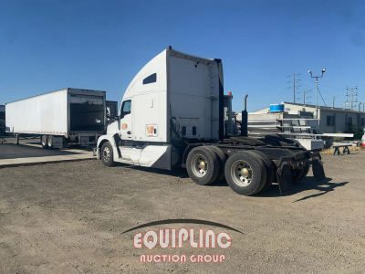 Kenworth T680 truck tractor in a used condition showing cab and rear dual axles, with trailer in background.