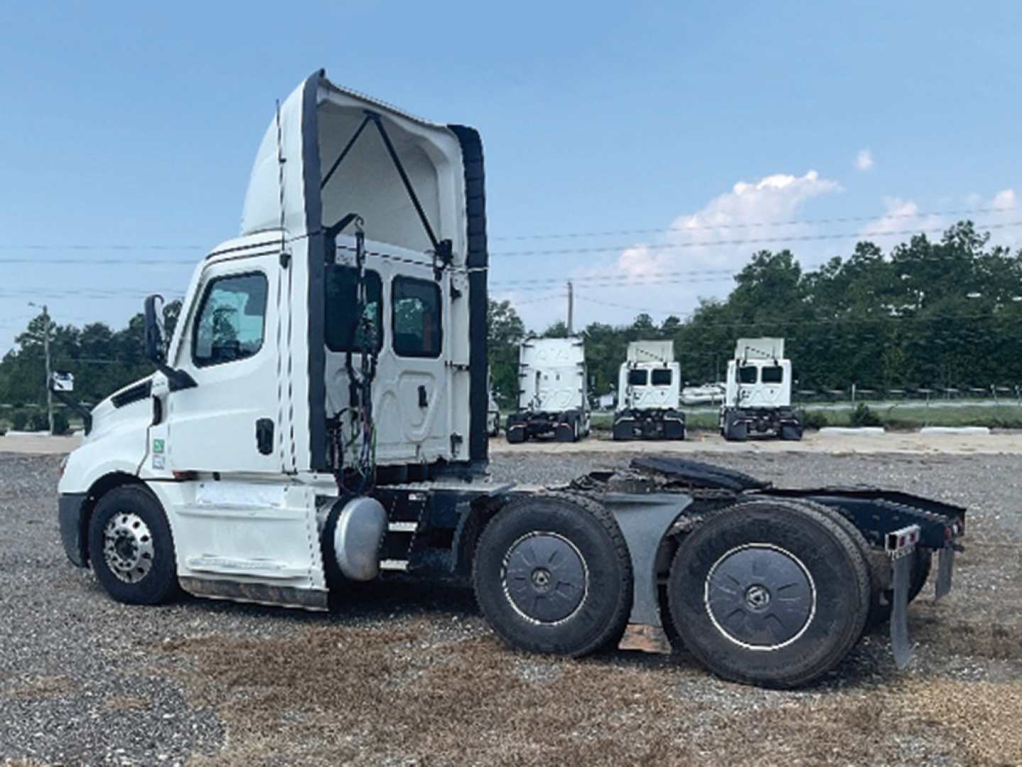 Freightliner Cascadia126 semi truck cab and chassis side view showing 6x4 axle configuration and sleeper area.