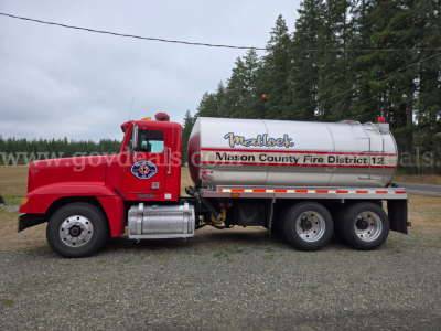 Tank truck side view showing red Freightliner FLD120 with silver cylindrical tank labeled Marybrook Mason County Fire District 12 and 3-axle rear, VIN 1FUYDDYB1TH744726.