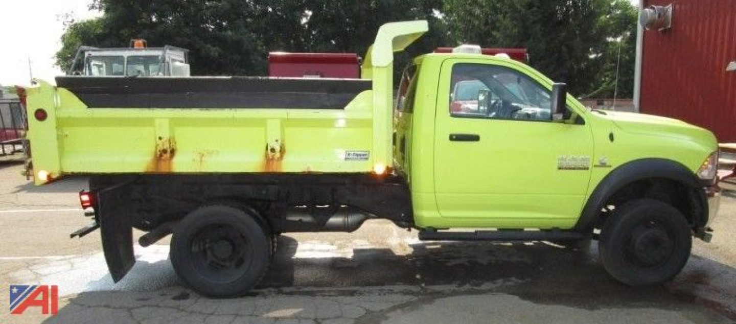 Ram 5500 dump truck with plow in lime green showing dump bed and side cab, side view.