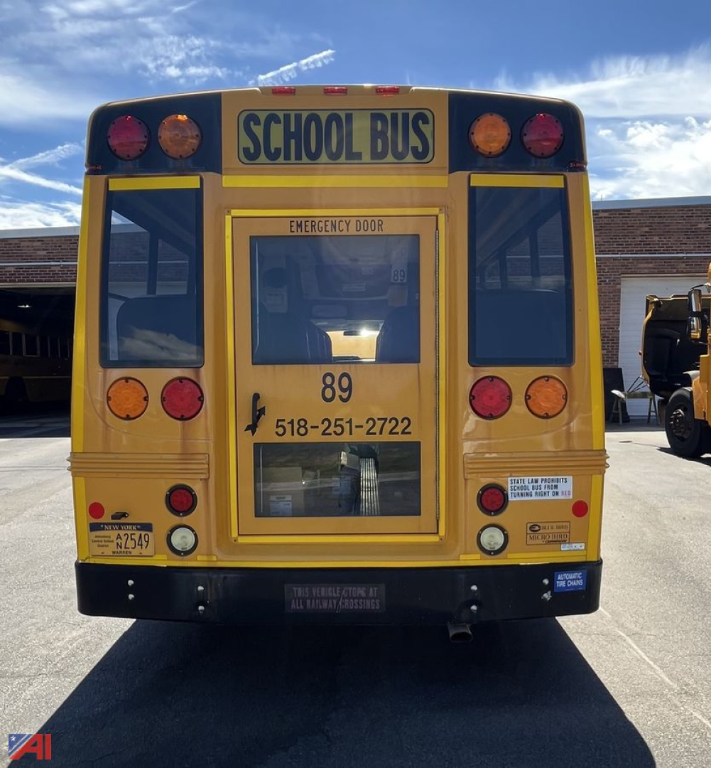 Ford Micro Bird cutaway school bus rear showing emergency door, school bus sign, rear lights, and contact number 518-251-2722.