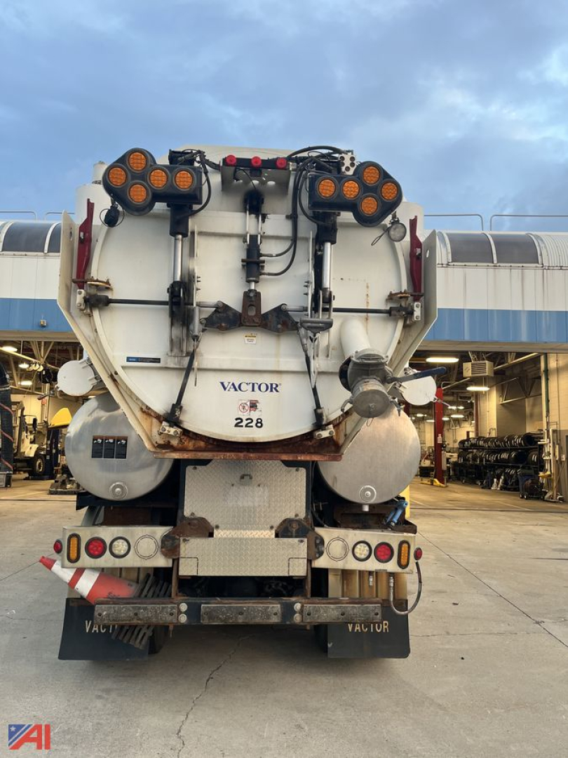 Rear view of a 2015 Freightliner 108 SD Vactor Truck showing dual rear vacuum tanks and warning lights.