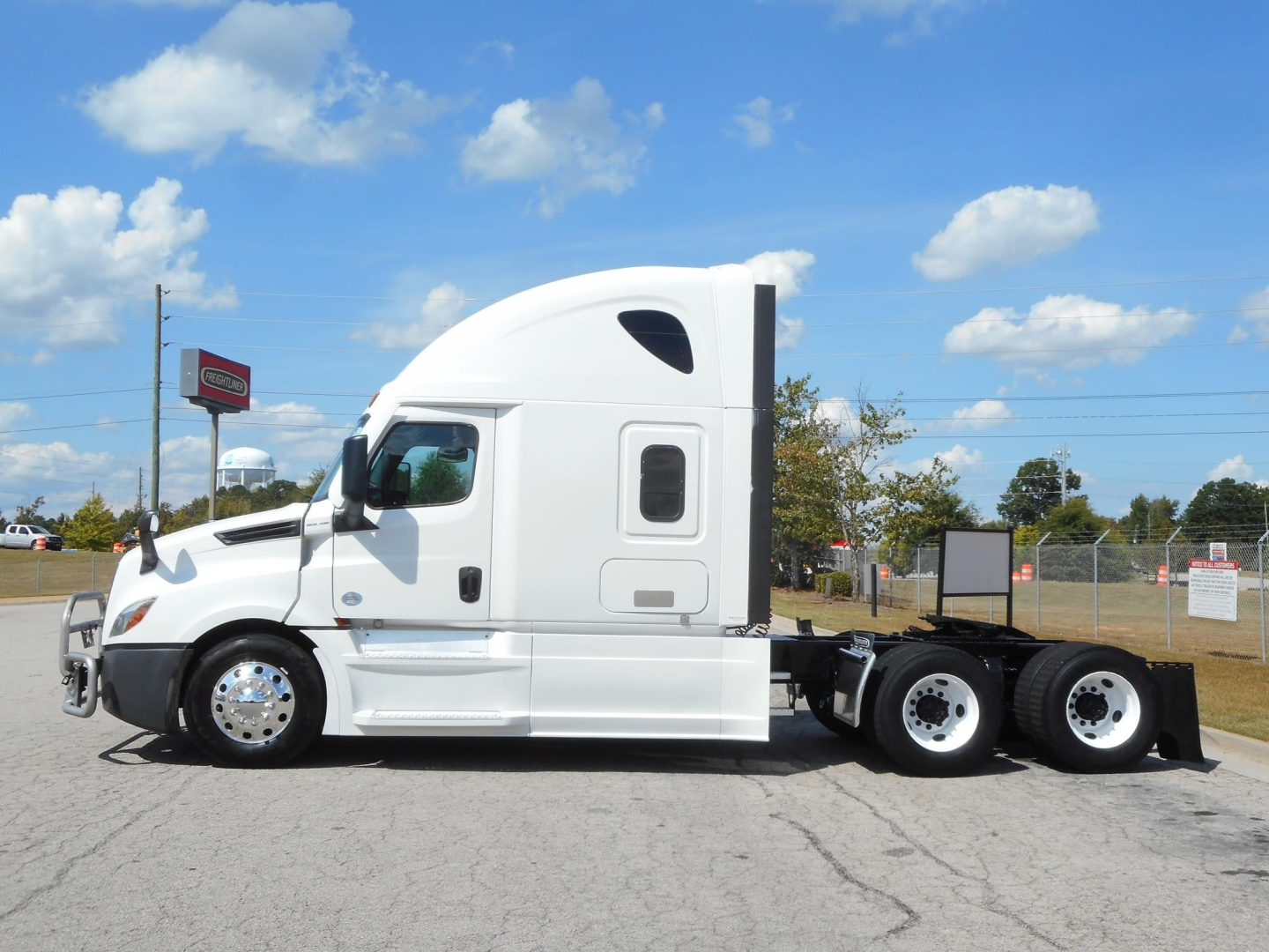 Freightliner Cascadia 126 tractor-trailer side view, white sleeper cab, dual rear axles, no visible damage.