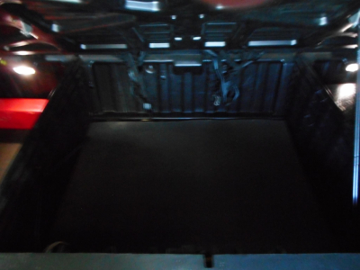 Freightliner Cascadia 126 truck bed area showing cargo space in the sleeper cab with dark flooring and side walls