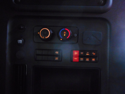 Dashboard cluster with climate controls and switches in a Freightliner Cascadia truck cab.