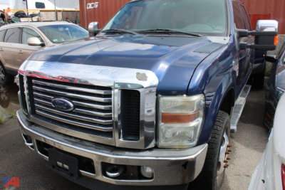 Ford F-350 Super Duty pickup truck front view in blue, partial damage to chrome bumper and grille area, 2010 model, parts-only listing.