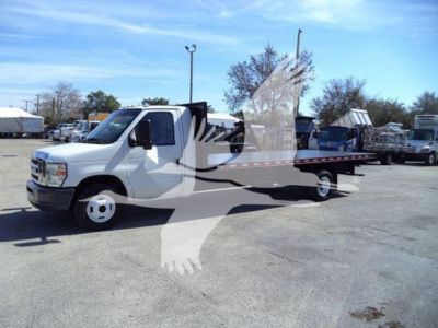 Ford E-450 flatbed tow truck with white cab and flatbed in a dealership lot, VIN 1FDXE4FS9BDA22070 visible in listing context.