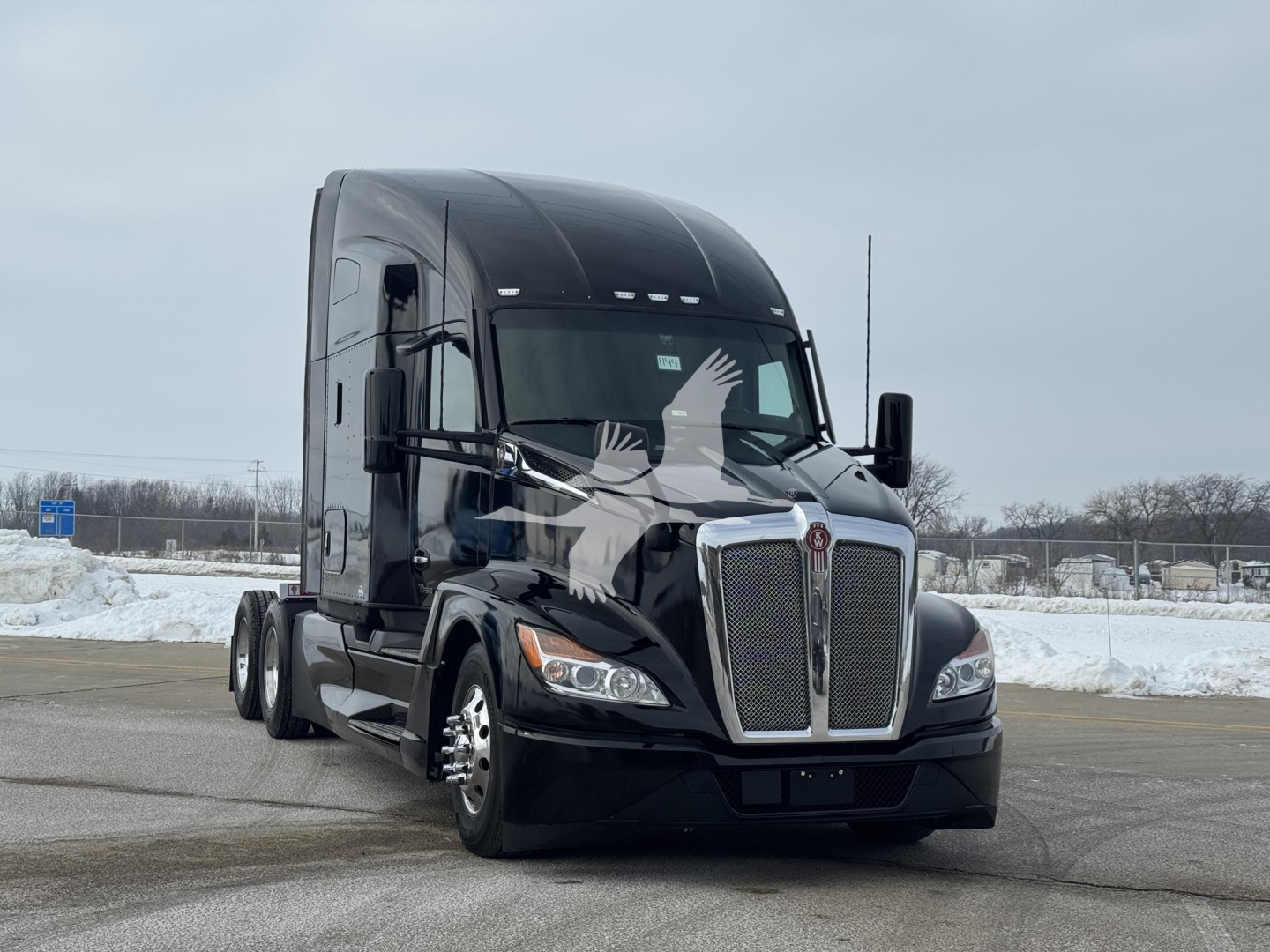 Kenworth T680 conventional sleeper truck with black paint, front grille, and dual rear axles visible.