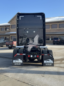 Kenworth T680 rear view showing black cargo area and dual rear mud flaps with Kordell Truck & Trailer Repair branding.