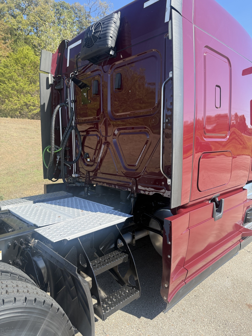Freightliner Cascadia126 truck rear sleeper with open chassis and access step, maroon exterior, spare tire mounted on back.
