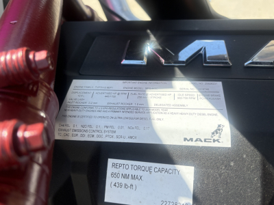 Mack PI64T engine bay badge area showing label with engine family and spec details; rebuilt torque capacity sticker reads 650 NM MAX (439 lb-ft).