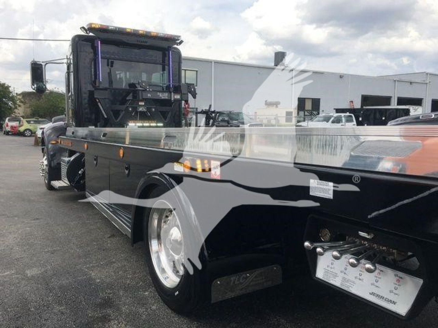 Peterbilt 337 rollback truck with extended flatbed and chrome components; side text visible on control panel area showing labels and gauges; stock number STEPSIDE337SRS.