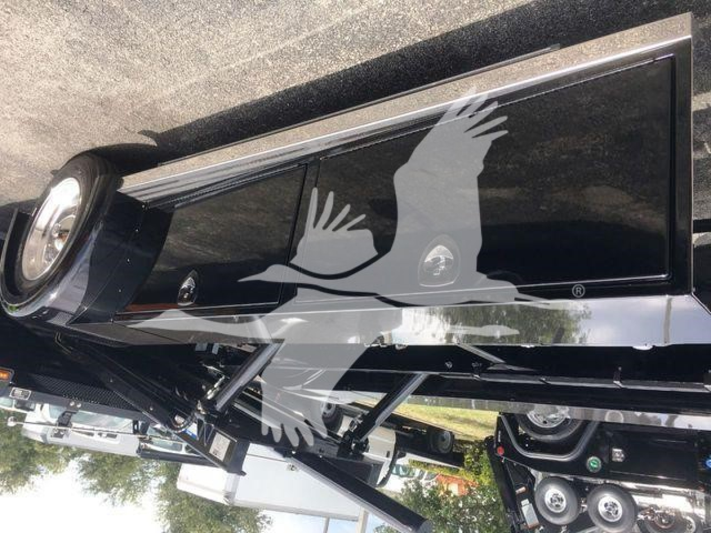 Peterbilt 337 rollback truck side view showing wheel, chrome frame, and window with logo watermark.