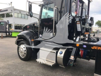Peterbilt 337 rollback truck side view showing front fender, chrome wheel, metallic step, and hydraulic components.
