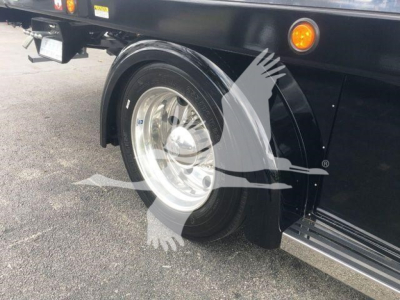 Peterbilt 337 rollback truck wheel and fender view showing chrome wheel, black fender, and side step.