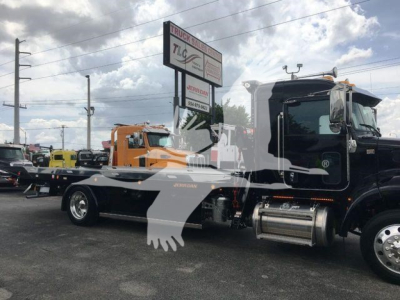 Peterbilt 337 truck cab and chassis in a dealership lot, Rollback category, black cab with chrome fuel tanks, stock number STEPSIDE337SRS.