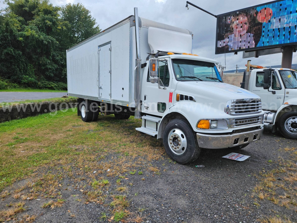 Box truck in a parking lot showing a white 2003 Sterling Acterra box truck with cargo box and front grille.