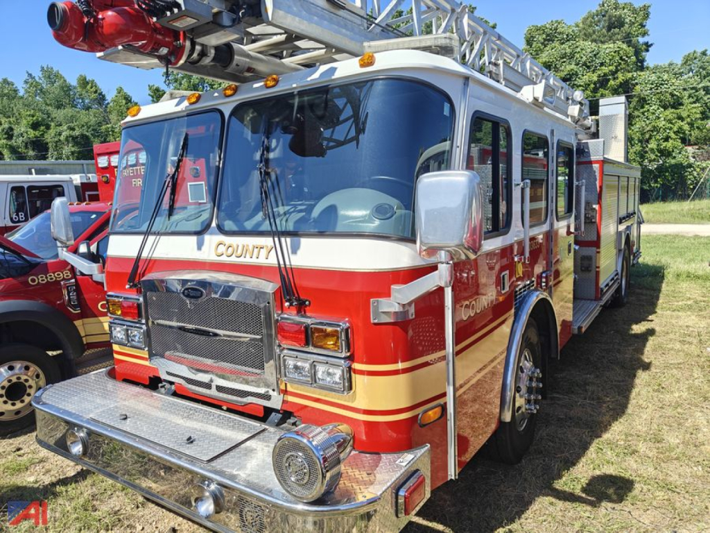 Fire truck cab over engine with COUNT on windshield and ladder rack, red and cream color scheme, front chrome bumper and grille.