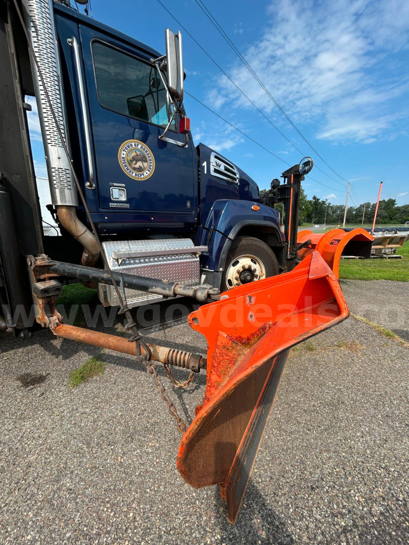 Truck cab of 2018 Western Star 4700 with front plow and side exhaust visible