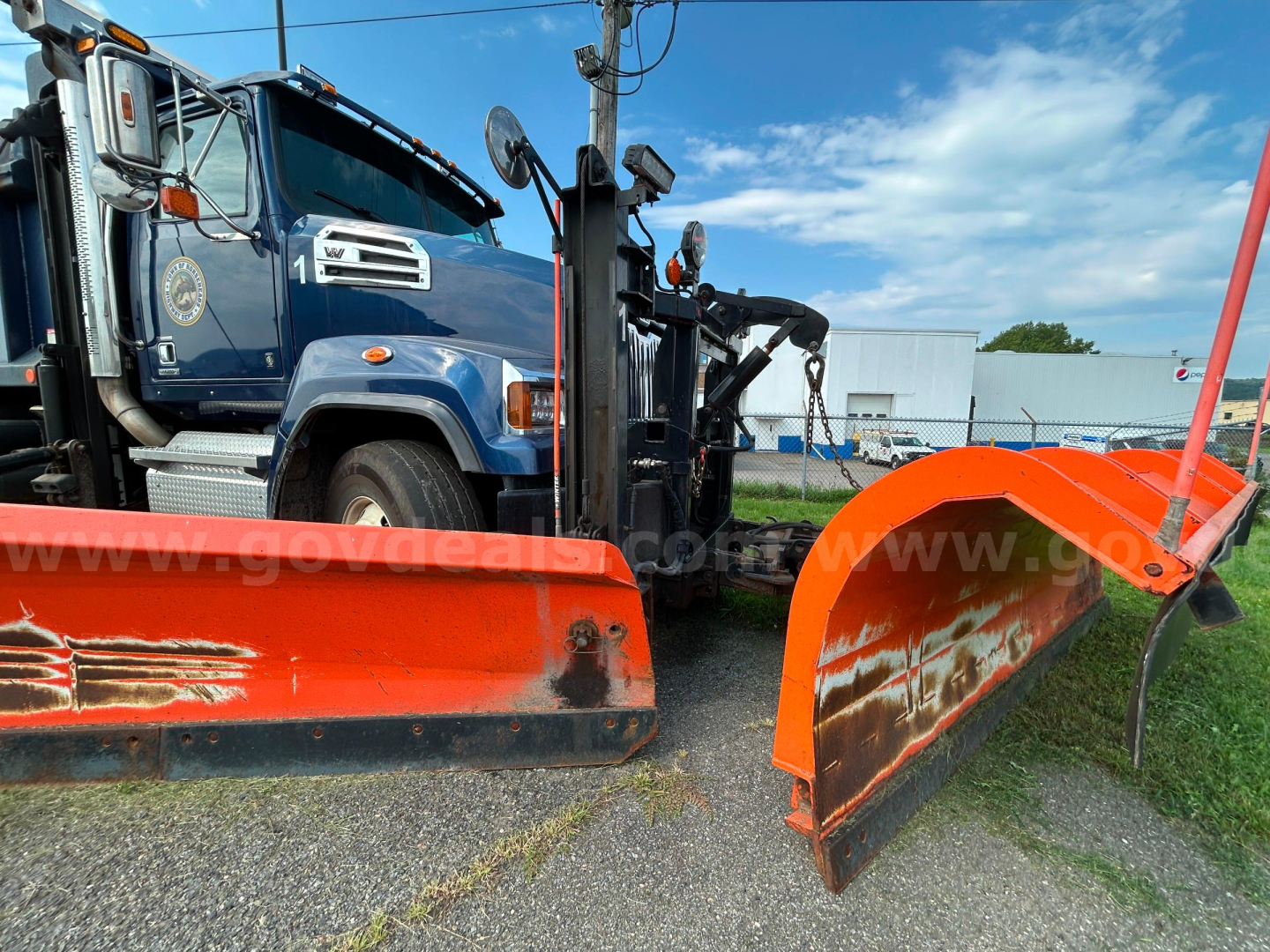 Blue Western Star 4700 truck with snow plow attachments and orange plow blades, VIN 5KKHAVDV4JLJP5790, stock 21869-48, parked on pavement.