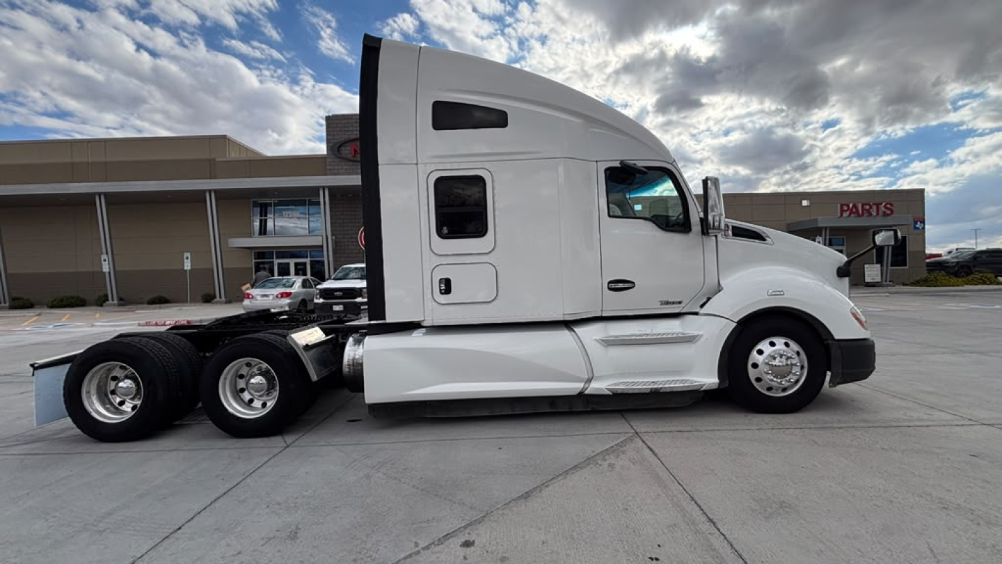 Kenworth T680 tractor side view showing sleeper cab and dual rear axles.