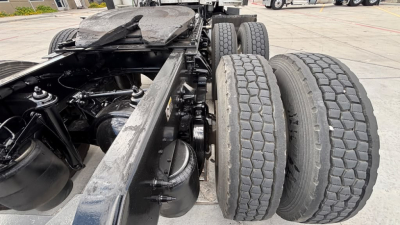 Kenworth T680 chassis showing dual rear axles and tires with frame rails and suspension components visible.